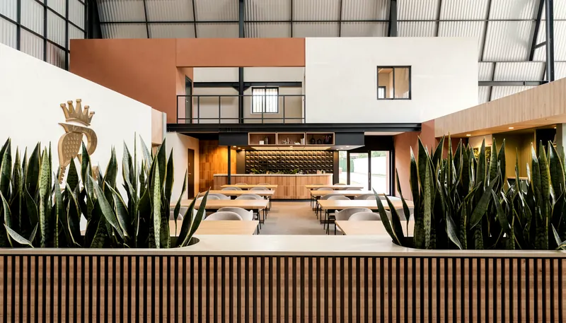 Dining tables between timber-slatted planters